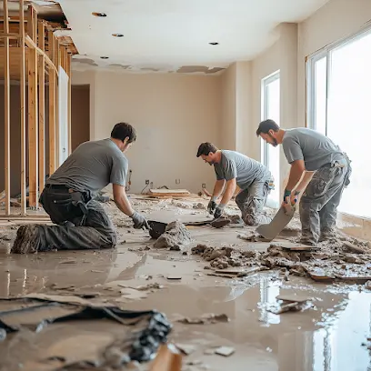 A crew removing soaked flooring after water damage in Arlington, TX