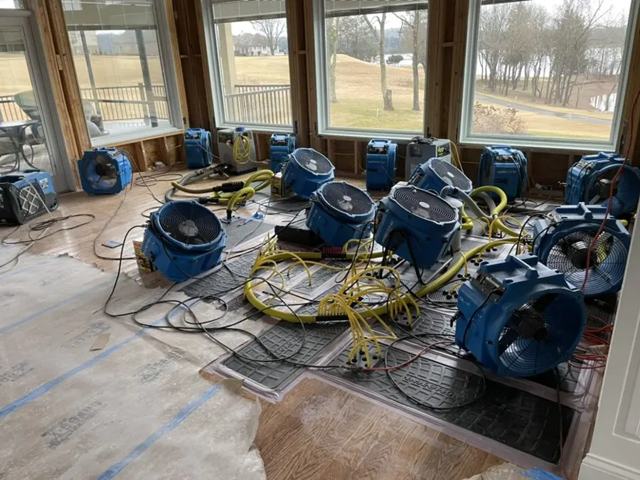 A row of air movers drying a large water loss in Arlington, TX